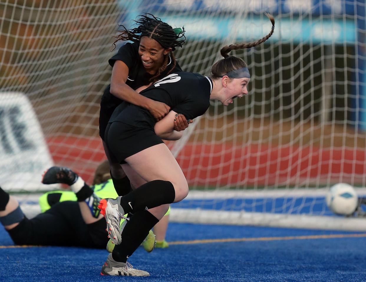 Klahowya's Amira Lyons embraces Bailey Watland (12) in front of the goal as the two celebrate Watland's goal making it 3-1 over Lynden Christian during the 1A State Championship game in Shoreline, Wash. on Saturday, Nov. 19, 2022.