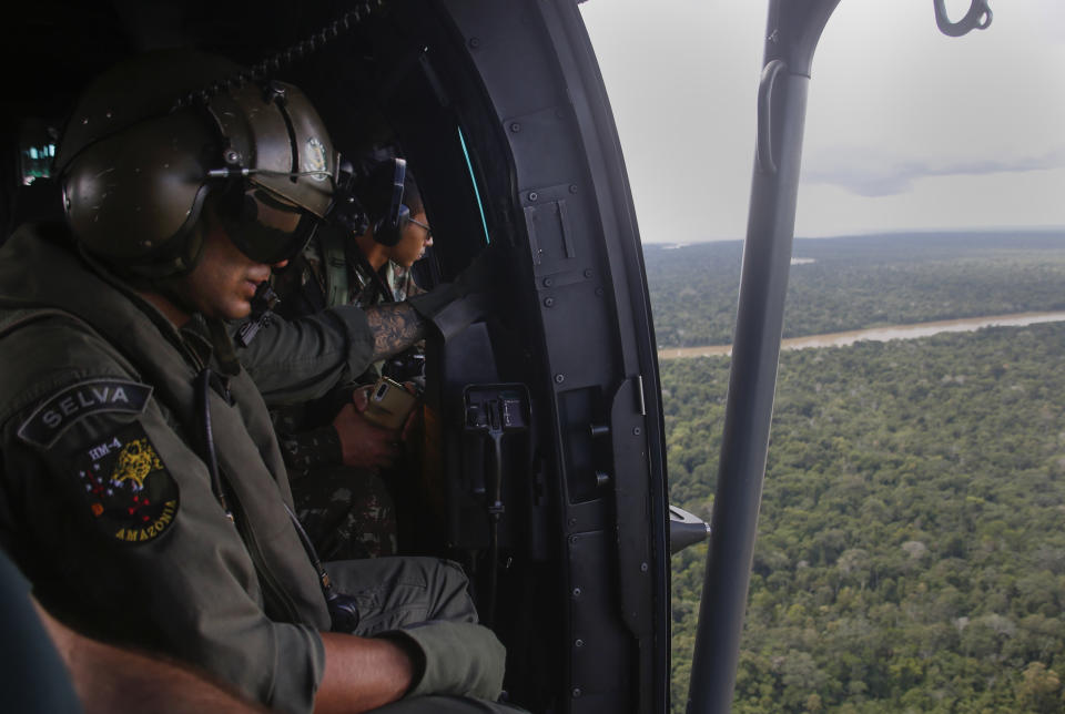 Soldiers search for missing British journalist Dom Phillips and Indigenous affairs expert Bruno Araujo Pereira from a helicopter over Javari Valley Indigenous territory, Atalaia do Norte, Amazonas state, Brazil, Friday, June 10, 2022. Phillips and Pereira were last seen on Sunday morning in the Javari Valley, Brazil's second-largest Indigenous territory which sits in an isolated area bordering Peru and Colombia. (AP Photo/Edmar Barros)