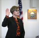 Attorney Jaye Rancourt is sworn in during the first day of a hearing for Owen Labrie on whether he deserves a new trial, on Tuesday, Feb. 21, 2017 in Concord, N.H. Labrie claims his trial lawyers failed to challenge the felony charge. He was acquitted in 2015 of raping a 15-year-old classmate as part of a game of sexual conquest at St. Paul's School but was convicted of a felony computer charge requiring him to register as a sex offender. (Geoff Forester /The Concord Monitor via AP, Pool)