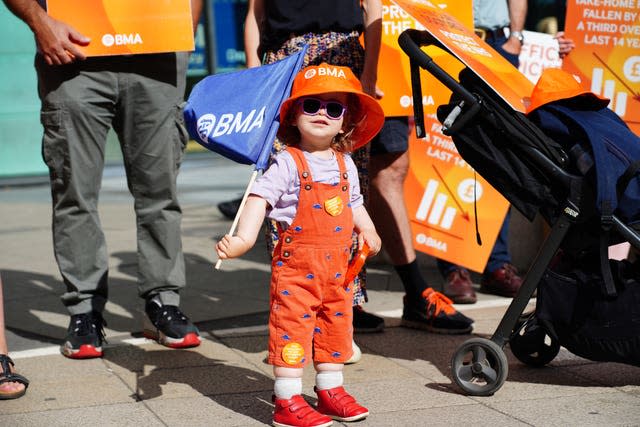 Edith (surname not given), age one, joins medical consultant members of the British Medical Association on the picket line outside Bristol Royal Infirmary in August 