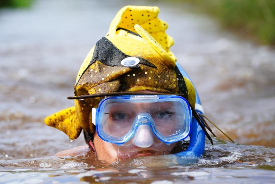 ompetitors in the bog section of the Rude Health Bog Triathlon at Llanwrtyd Wells, in Wales (Ben Birchall/PA) (PA Wire)
