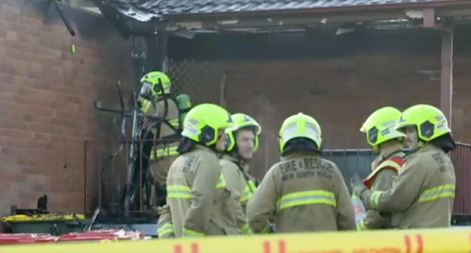 Fire crews outside the smouldering Singleton home. Two girls, aged 5, and an 11-year-old boy died after the home went up in flames on Wednesday morning. A 31-year-old woman and an eight-year-old boy are in a stable condition at John Hunter Hospital.