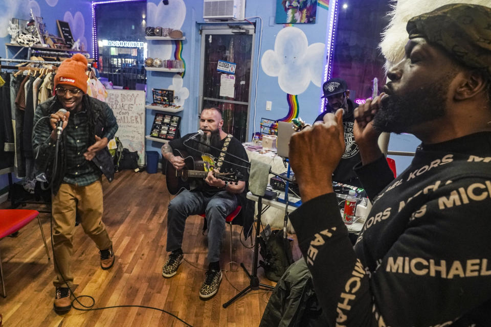Crypto investor Tyrone Norris, also known as Mental Stamina, right, jams along with rapper Mozay Calloway, left, and singer Don "Petty Christ" Paradise, during their performance at a popup livestream event for "Hiphop.Game," a metaverse platform Norris created to market NFTs and its related cryptocurrency "@Joincoin," Friday Jan. 27, 2023, at Love Gallery in Brooklyn, N.Y. (AP Photo/Bebeto Matthews)