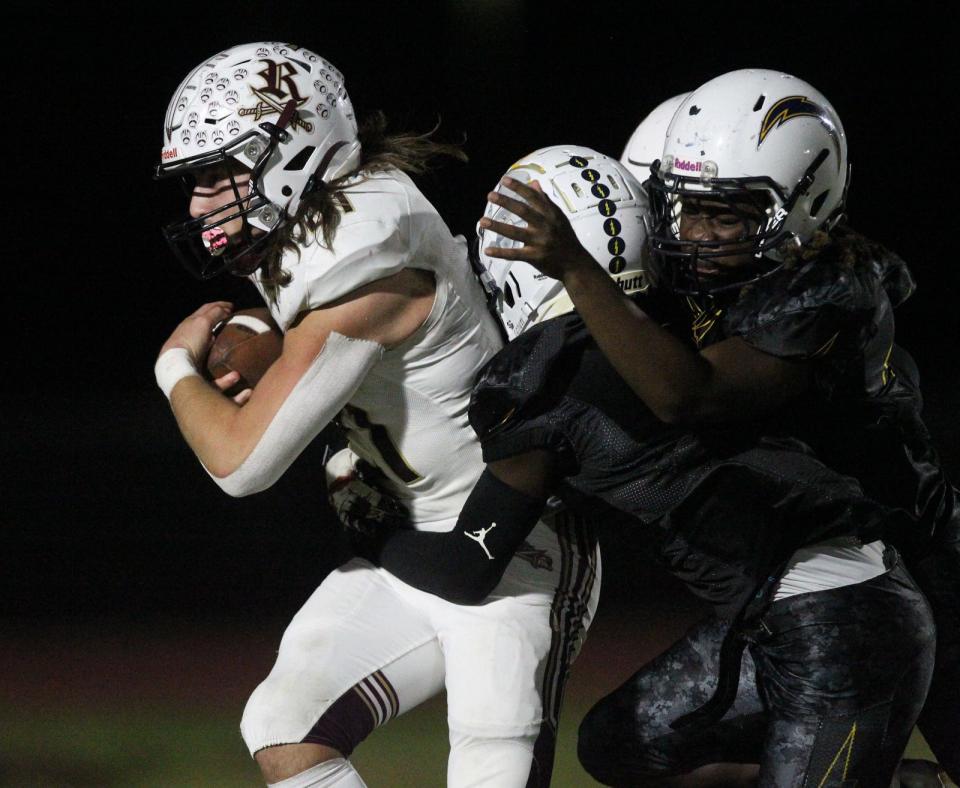 Riverdale player Cole Hayes drags defenders into the end zone with him as he ends up scoring a touchdown on the play. The Riverdale High School Raiders visited the Lehigh Senior High School Lightning for a Thursday night matchup Oct. 26, 2023. The Lightning came up with the big win with a final score of 14-48.