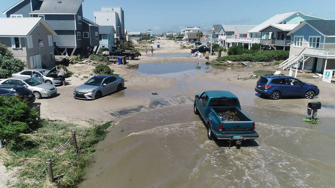 Oak Island sustained wind and flood damage caused by Hurricane Isaias leaving the streets strewn with debris and covered with more than a foot of sand in areas close to the beach Tuesday, August 4, 2020.