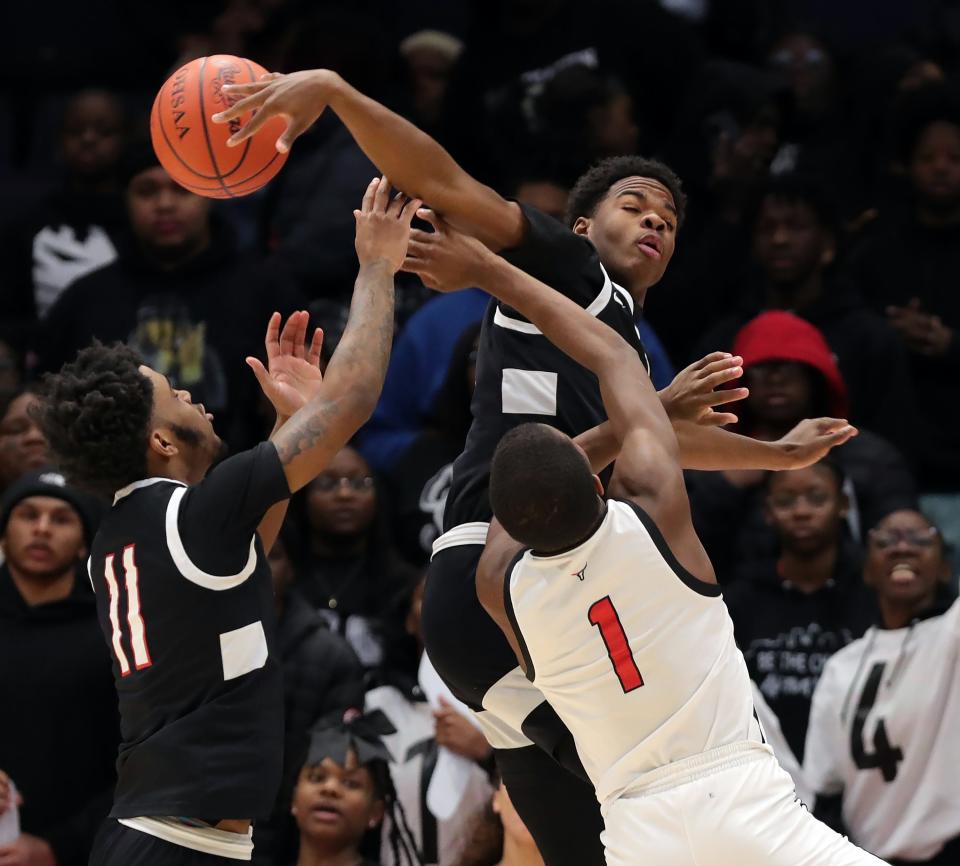 Buchtel guard Stevie Diamond, top, blocks the shot of Lutheran West guard Derek Fairley during the first half of the OHSAA Division II state final, Sunday, March 19, 2023, in Dayton.