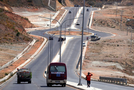 A local walks along a newly constructed road that was funded by the Chinese government, located near the venue for the Asia Pacific Economic Cooperation (APEC) forum in Port Moresby, Papua New Guinea, November 15, 2018. REUTERS/David Gray