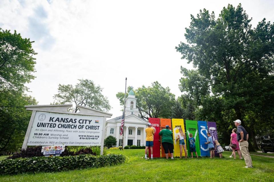 Church and community members sanded off an anti-LGBTQ message spray painted on doors vandalized on the lawn of Kansas City United Church of Christ, 205 W. 65th St., on Thursday, July 7, 2022. The group was preparing to repaint the symbolic doors after the damage was discovered outside the church.