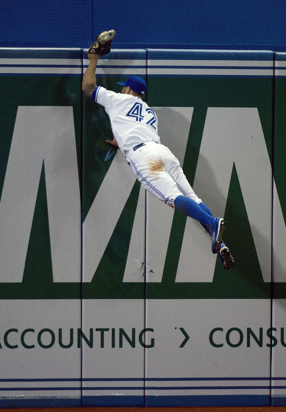 Toronto Blue Jays left fielder Kevin Pillar makes a catch on the other side of the wall hit by Tampa Bay Rays Tim Beckham during the seventh inning of a baseball game, Wednesday, April 15, 2015 in Toronto. (Nathan Denette/The Canadian Press via AP) MANDATORY CREDIT