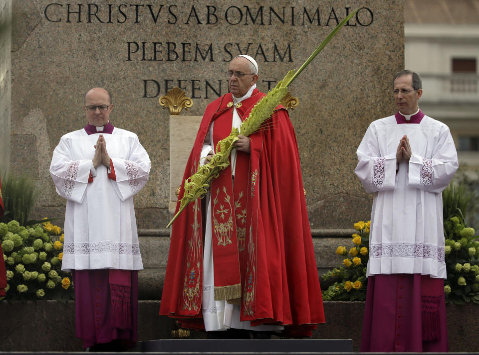 Pope Francis, center, celebrates a Palm Sunday mass in St. Peter's Square, at the Vatican, Sunday, April 13, 2014. (AP Photo/Gregorio Borgia)