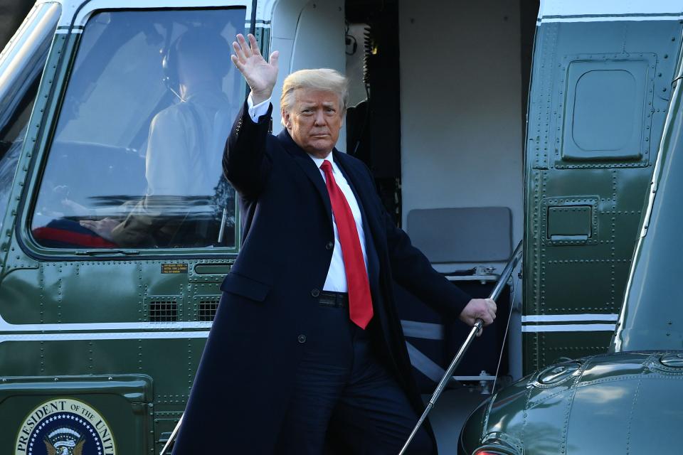 Outgoing US President Donald Trump waves as he boards Marine One at the White House in Washington, DC, on January 20, 2021.