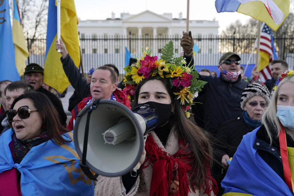 People gather following a vigil and march in solidarity with Ukraine outside the White House in Washington, Sunday, Feb. 20, 2022. (AP Photo/Patrick Semansky)