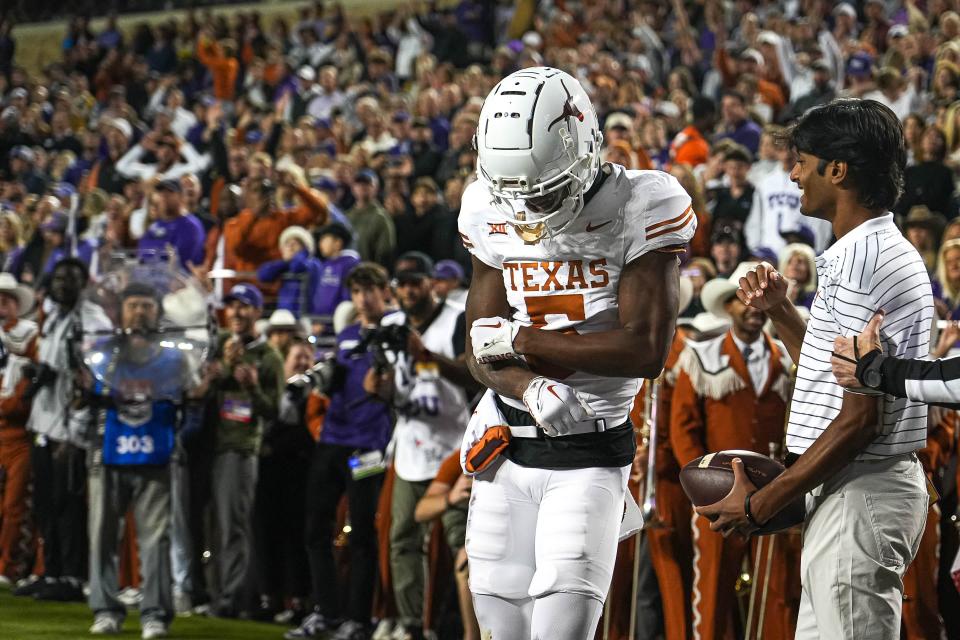 Texas wide receiver Adonai Mitchell celebrates a touchdown in the win over TCU on Saturday in Fort Worth. He had just three catches, but they all came at critical moments in the game, including a game-sealing reception on third down in the final 2 minutes.