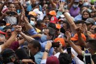 Opposition leaders Juan Guaido, center left, and Freddy Superlano, greet supporters during a demonstration in support of Superlano, in Barinas, Venezuela, Saturday, Dec. 4, 2021. Superlano, who was leading the race for governor in Barinas State in the recent Nov. 21 regional elections, called for a protest this Saturday after a court ruling ordered new elections in the state and disqualified him from running. (AP Photo/Ariana Cubillos)