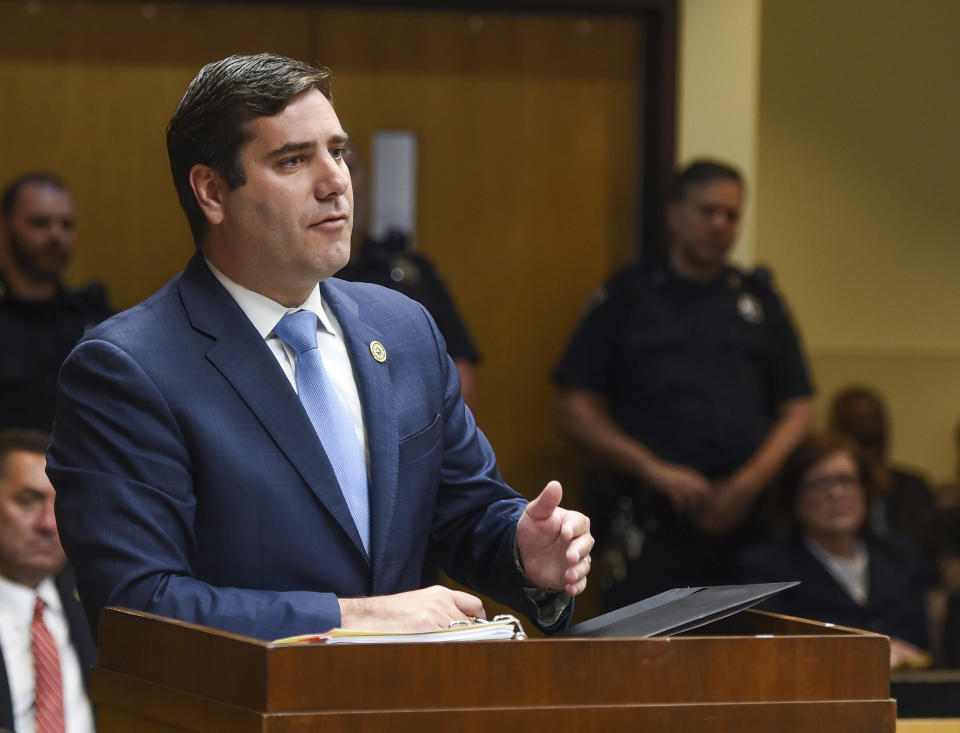 Suffolk County District Attorney Tim Sini addresses the judge during a hearing for Keith Bush, who was convicted of murdering a classmate in 1975, Wednesday, May 22, 2019 at the Suffolk County Courthouse in Riverhead, N.Y. Sini went to court with Bush's attorney seeking to have the conviction overturned after a case review found Long Island prosecutors had long hid the fact that police looked at another possible suspect. (James Carbone/Newsday via AP, Pool)