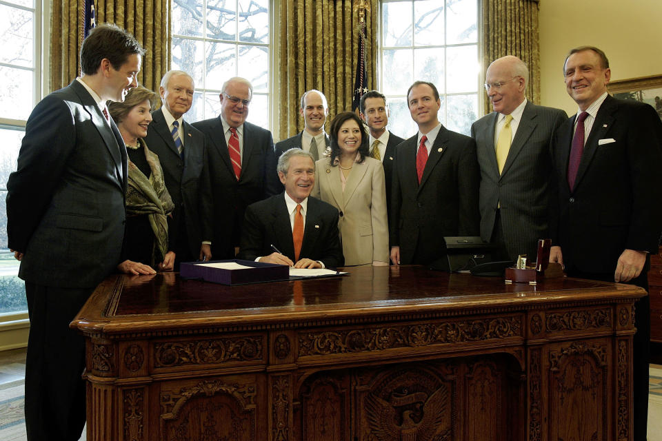 : U.S. President George W. Bush (C) prepares to sign a bill as (L-R) Rep. Mark Green (R-WI), first lady Laura Bush, Sen. Orrin Hatch (R-UT), Rep. James Sensenbrenner (R-WI), Rep. Rick Larsen (D-WA), Rep. Hilda Solis (D-CA), Rep. Anthony Weiner (D-NY), Rep. Adam Schiff (D-CA), Sen. Patrick Leahy (D-VT) and Sen. Arlen Specter (R-PA) look on during a signing ceremony in the Oval Office of the White House January 5, 2006 in Washington, DC. Bush signed the Violence Against Women and Department of Justice Reauthorization Act of 2005 into law on January 5, 2006.&nbsp;