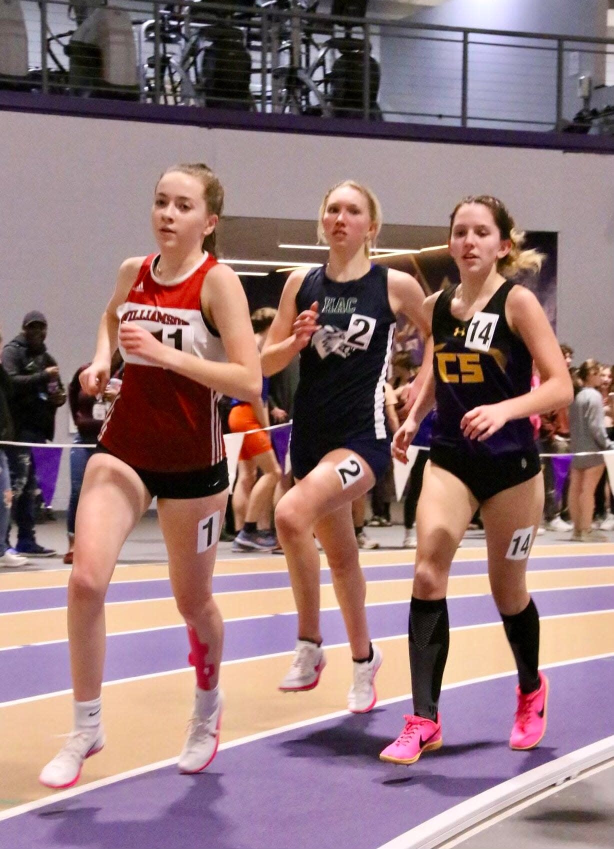 Williamson sophomore Hannah Governor, left, running with Harley Allendale Columbia's Evelyn Kacprzynski, middle, and Clyde-Savannah junior Jessica Sullivan in the indoor track 3,000-meter race during the Wayne-Finger Lakes Championships.