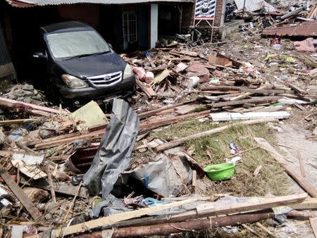 A damaged car is seen at a broken house after earthquake hit in Palu, Indonesia September 29, 2018. REUTERS/Stringer