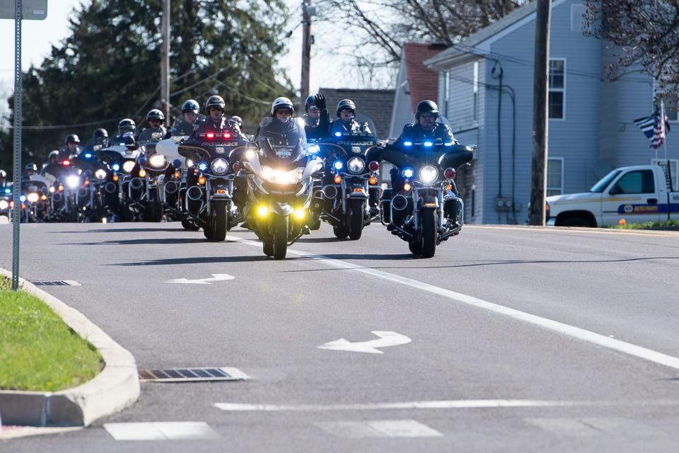 Police officers on motorcycles lead the funeral procession for Lebanon City Police Lt. William Lebo on Friday, April 8, 2022, in Derry Township.