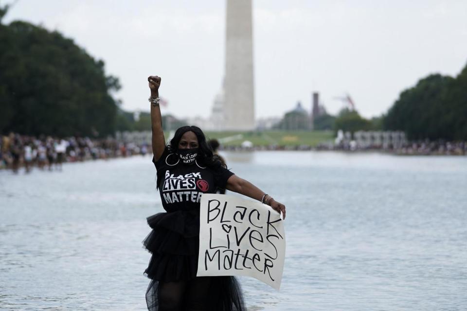 Attendees stand in the reflecting pool near the Lincoln Memorial during the March on Washington (Getty Images)