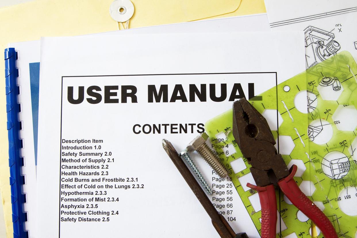 user manual guide brochure against tools and documents