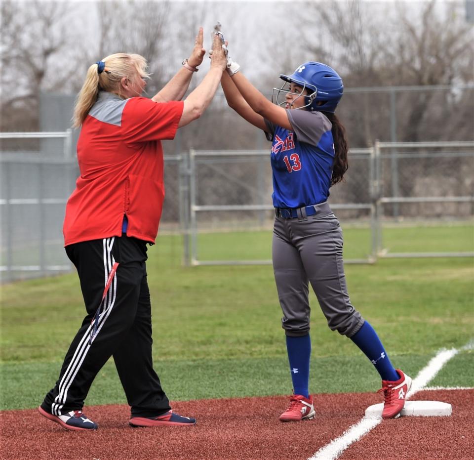 Cooper's Nadia Garcia, right, celebrates with coach Stacey Herring after hitting a two-out triple in the second inning. She was left stranded.