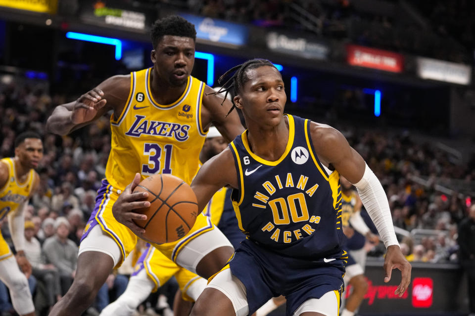 Indiana Pacers guard Bennedict Mathurin (00) picks up a rebound in front of Los Angeles Lakers center Thomas Bryant (31) during the second half of an NBA basketball game in Indianapolis, Thursday, Feb. 2, 2023. The Lakers defeated the Pacers 112-111. (AP Photo/Michael Conroy)