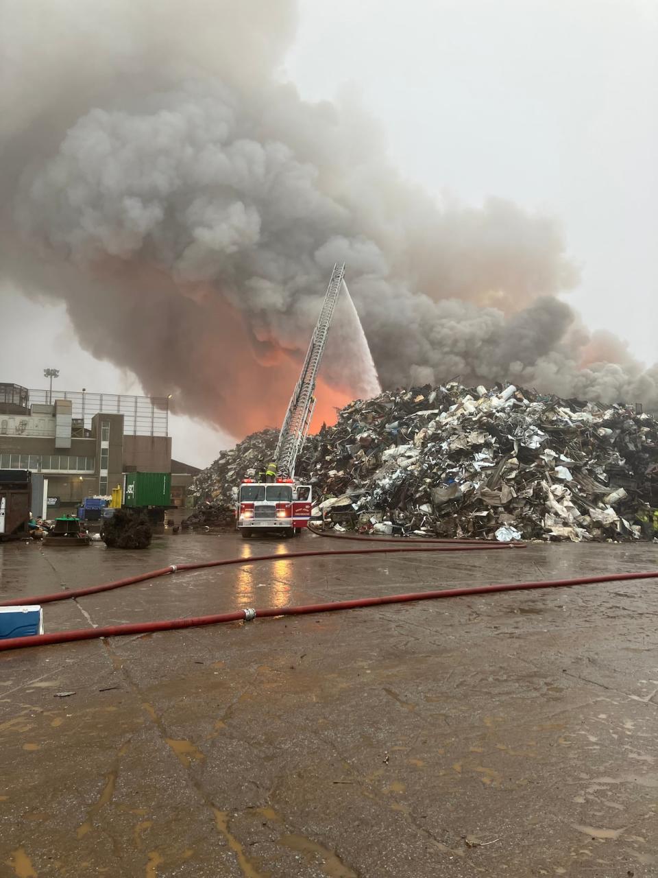 Crews are focusing on making sure the fire in one pile of scrap doesn't spread to other piles.