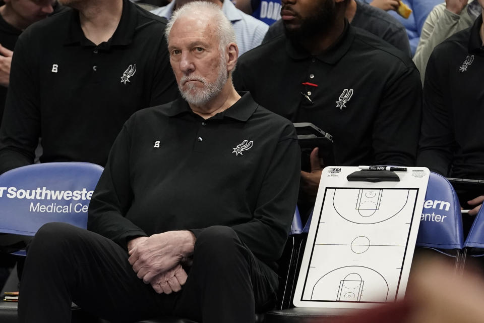 San Antonio Spurs beach coach Gregg Popovich sits on the bench during the first quarter of an NBA basketball game against the Dallas Mavericks in Dallas, Sunday, April 9, 2023. (AP Photo/LM Otero)