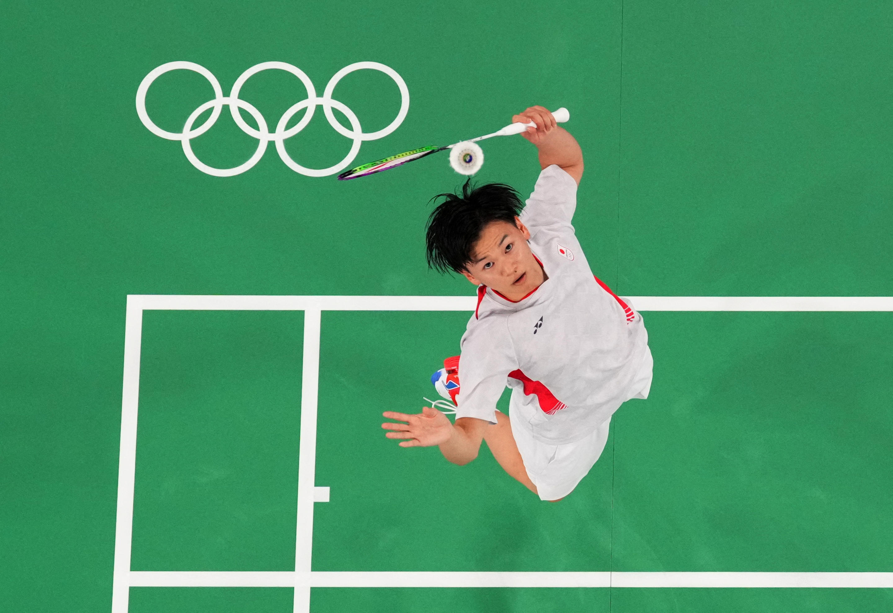 Paris 2024 Olympics - stage - Porte de La Chapelle Arena, Paris, France - July 29, 2024. Yuta Watanabe of Japan in action during the Group C Badminton - Mixed Doubles match with Arisa Higashino of Japan against Chun Man Tang of Hong Kong and Ying Suet Tse of Hong Kong on July 29, 2024. (Dylan Martinez/Reuters)