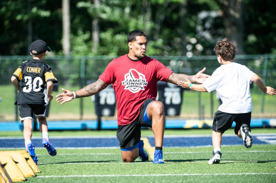 James Conner, Arizona Cardinals running back and McDowell graduate, provides personalized coaching to youth, on July 9, during his inaugural youth football camp at Gus Anderson Field at McDowell High School in Millcreek Township. The camp held two back to back sessions for youth ages 7-13 and for youth ages 14-17 .