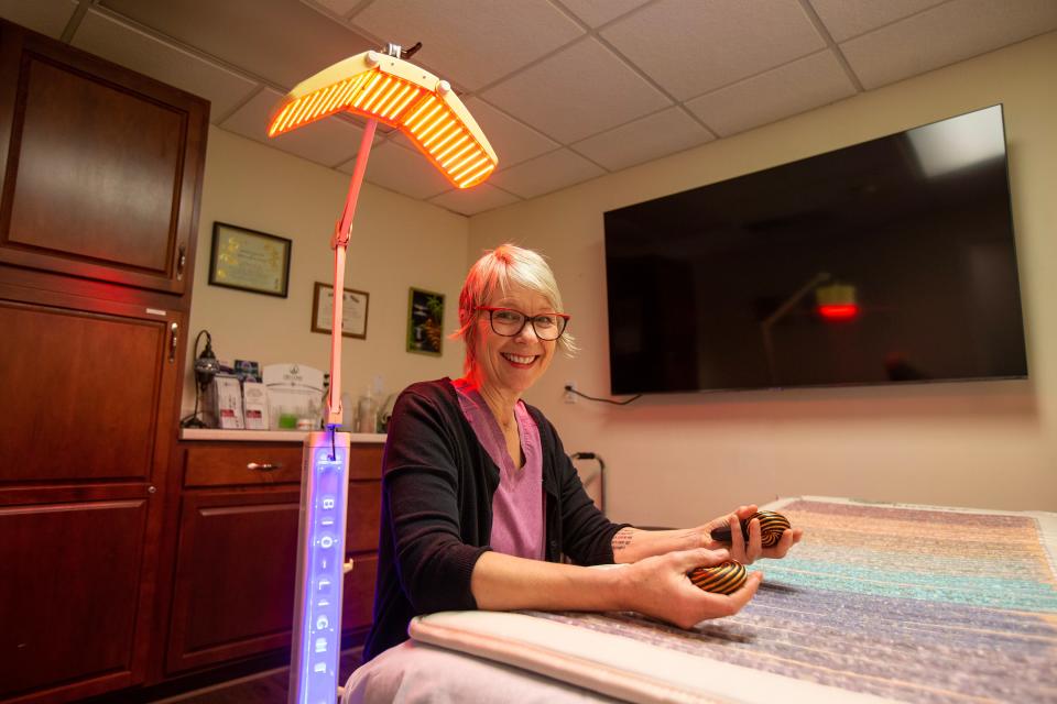 Heather Lawrence, owner of The Detox Box, a natural health studio which provides bodywork, light and sound therapy sessions, features her crystal energy mat, infrared heat lamp and copper healing coils inside the Holistic Healing Center in Colts Neck, NJ Tuesday, January 24, 2023. 