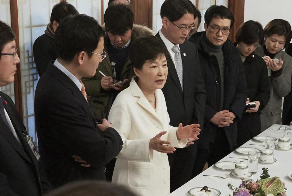 In this photo provided by the South Korean Presidential House, impeached South Korean President Park Geun-hye, third from left, speaks during a meeting with a selected group of reporters at the presidential house in Seoul, South Korea, Sunday, Jan. 1, 2017. Park vehemently rejected accusations Sunday that she conspired with a longtime friend to extort money and favors from companies, accusing her opponents of framing her. (The South Korean Presidential House via AP)
