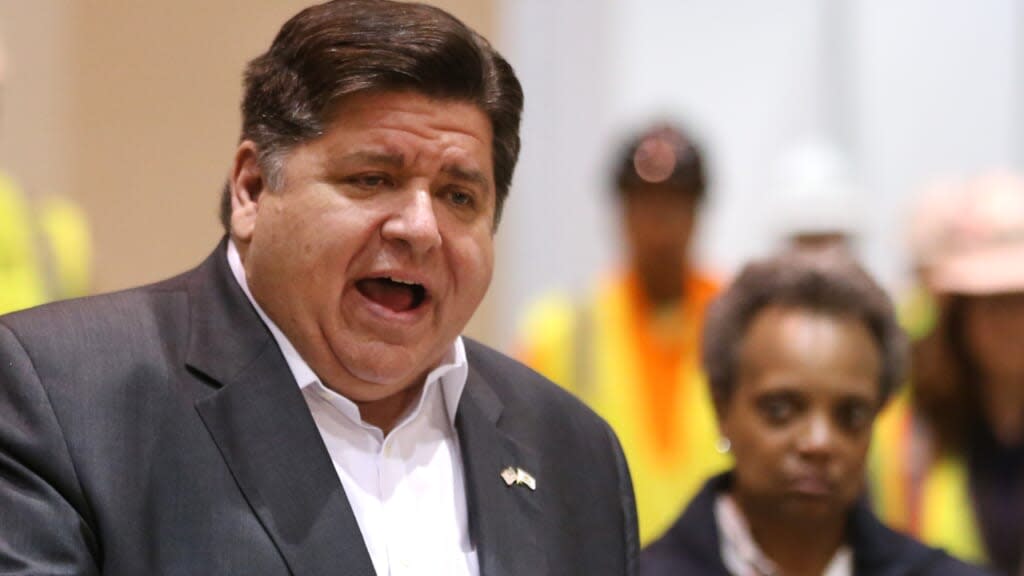 (L-R) Illinois Gov. J.B. Pritzker speaks and Chicago Mayor Lori Lightfoot listens during an April 2020 press conference held after they toured a facility to treat COVID-19 patients. (Photo by Chris Sweda-Pool via Getty Images)