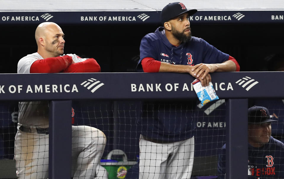 Boston Red Sox Steve Pearce, left, and Red Sox starting pitcher David Price watch from the dugout during the ninth inning of the Red Sox 5-3 loss to the New York Yankees in a baseball game, Wednesday, April 17, 2019, in New York. (AP Photo/Kathy Willens)
