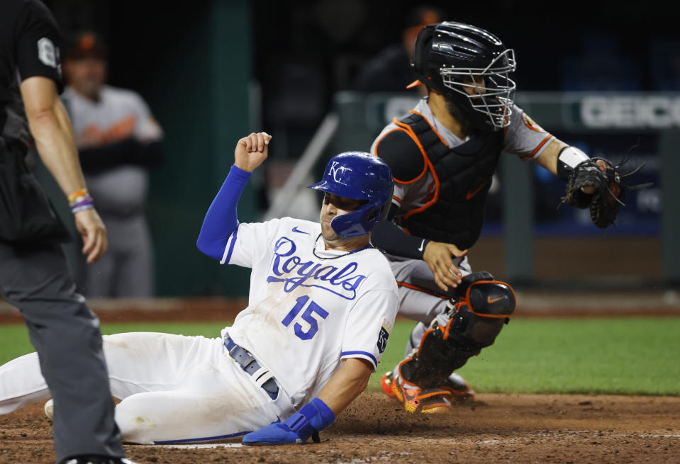 Kansas City Royals' Whit Merrifield (15) scores past Baltimore Orioles catcher Robinson Chirinos during the sixth inning of a baseball game in Kansas City, Mo., Thursday, June 9, 2022. (AP Photo/Colin E. Braley)