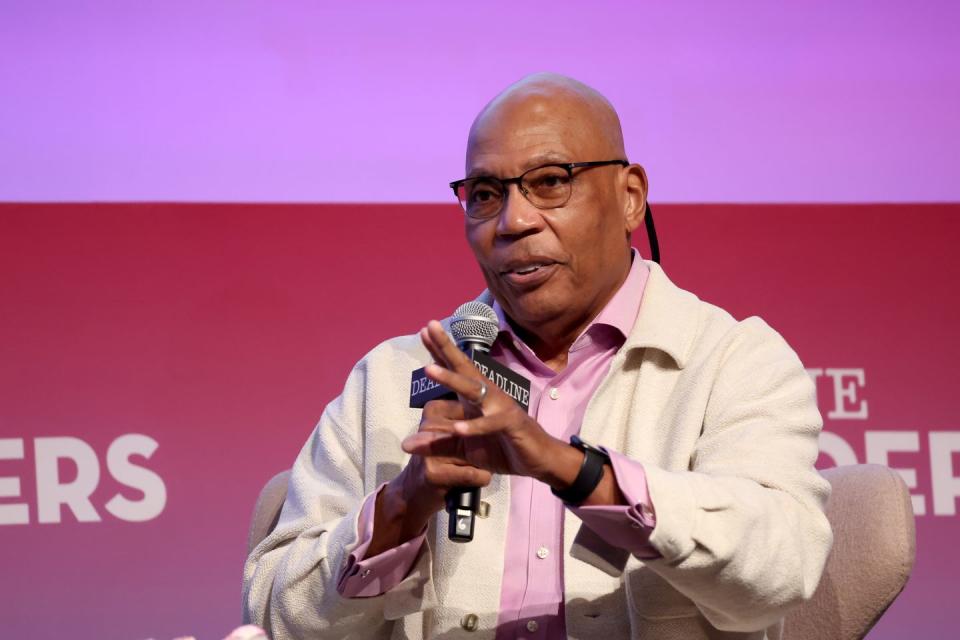 paris barclay gesturing with his left hand as he speaks to a crowd with a microphone