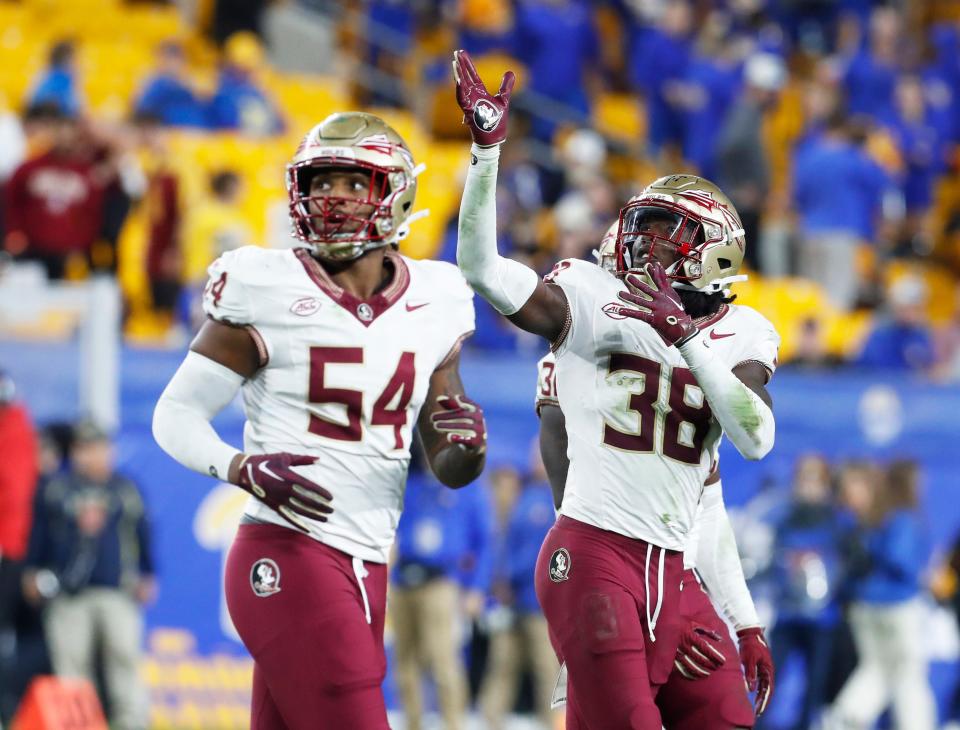 Florida State Seminoles defensive back Shyheim Brown (38) celebrates his fumble recovery alongside defensive lineman Byron Turner Jr. (54) against the Pittsburgh Panthers during the fourth quarter Nov. 4, 2023, at Acrisure Stadium in Pittsburgh, Pennsylvania.