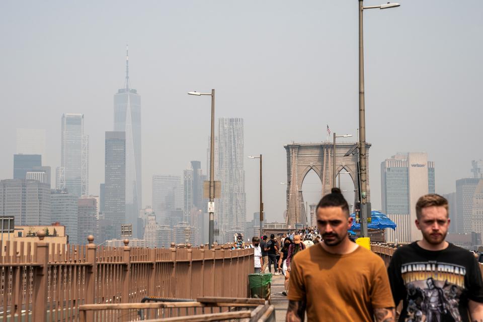 Smoke from wildfires in Canada shrouds the Freedom Tower seen from the Brooklyn Bridge on June 30, 2023 in New York City.