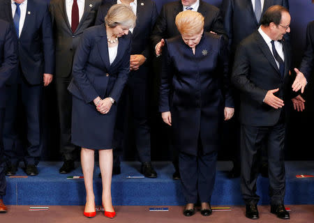 (L-R) Britain's Prime Minister Theresa May, Lithuania's President Dalia Grybauskaite and France's President Francois Hollande pose for a family photo during a European Union leaders summit in Brussels, Belgium, October 20, 2016. REUTERS/Francois Lenoir