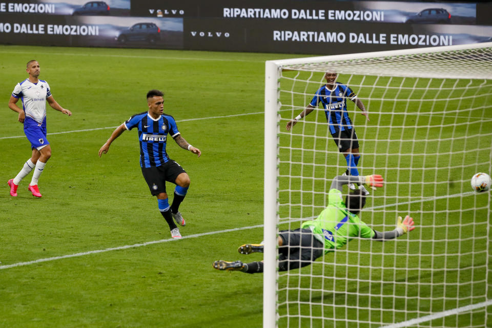 Inter Milan's Lautaro Martinez, second from left, scores his side's second goal past Sampdoria's goalkeeper Emil Audero during the Serie A soccer match between Inter Milan and Sampdoria at the San Siro Stadium, in Milan, Italy, Sunday, June 21, 2020. (AP Photo/Antonio Calanni)