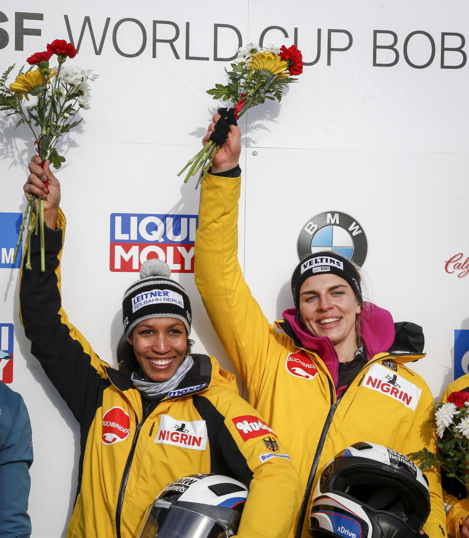 Germany's Mariama Jamanka, left, and Annika Drazeky, celebrate their victory in the women's World Cup bobsled event in Calgary, Saturday, Feb. 23, 2019. (Jeff McIntosh/The Canadian Press via AP)