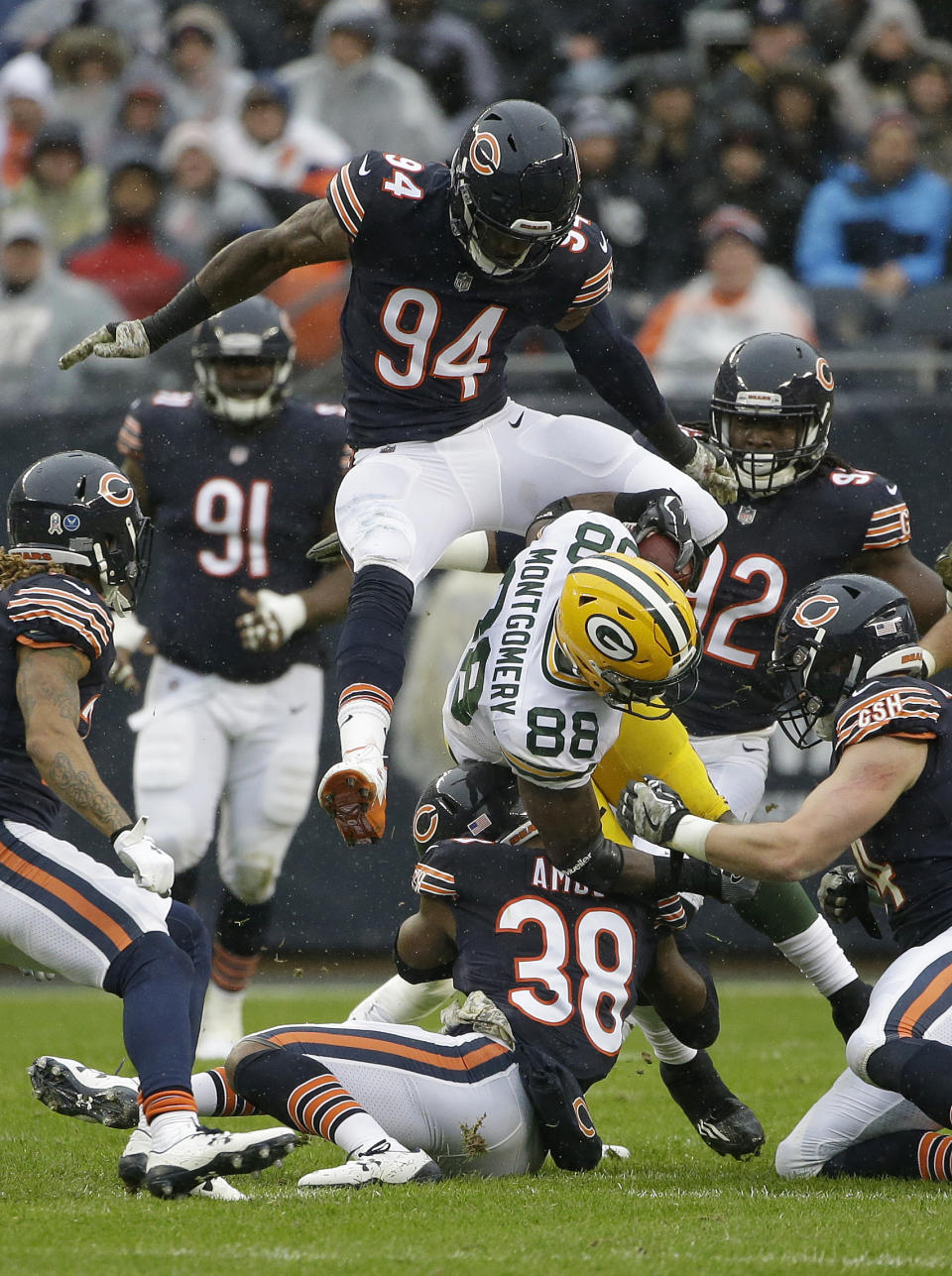 <p>Chicago Bears’ Leonard Floyd (94) leaps over as the Bears strong safety Adrian Amos (38) tackles Green Bay Packers running back Ty Montgomery (88) during the first half of an NFL football game, Sunday, Nov. 12, 2017, in Chicago. (AP Photo/Nam Y. Huh) </p>