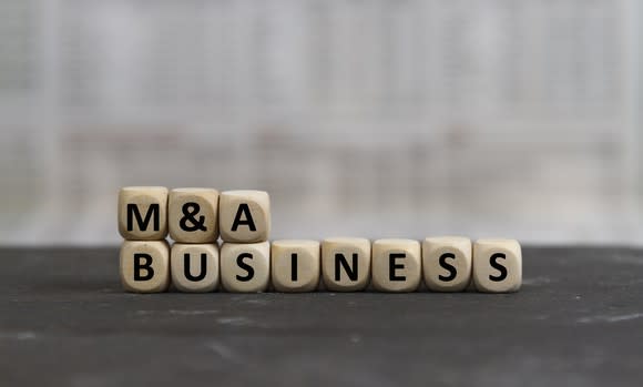 "M&A Business" spelled out with wood blocks. 