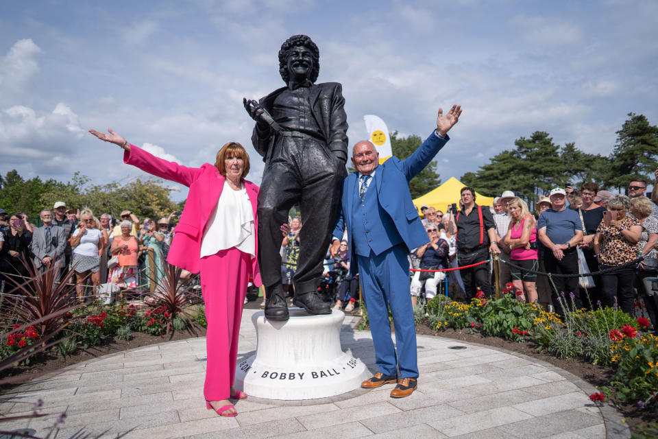 Tommy Cannon and wife Yvonne Ball stand with Bobbyâ€™s statue. The unveiling of the Bobby Ball statue at Lowther Gardens, Lytham, Lancashire, August 28 2022. 