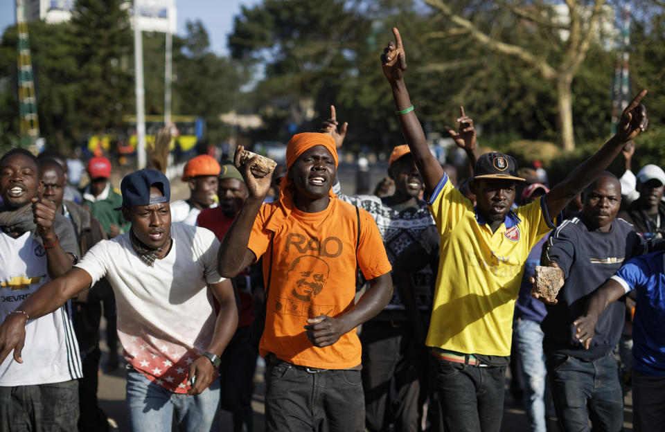 <p>Supporters of opposition leader Raila Odinga, one wearing a t-shirt with his picture, gather in advance of a mock “swearing-in” ceremony of Odinga at Uhuru Park in downtown Nairobi, Kenya Tuesday, Jan. 30, 2018. (Photo: Ben Curtis/AP) </p>