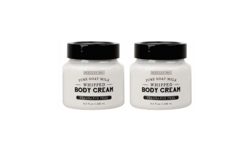 Two jars of whipped body cream with black lids.