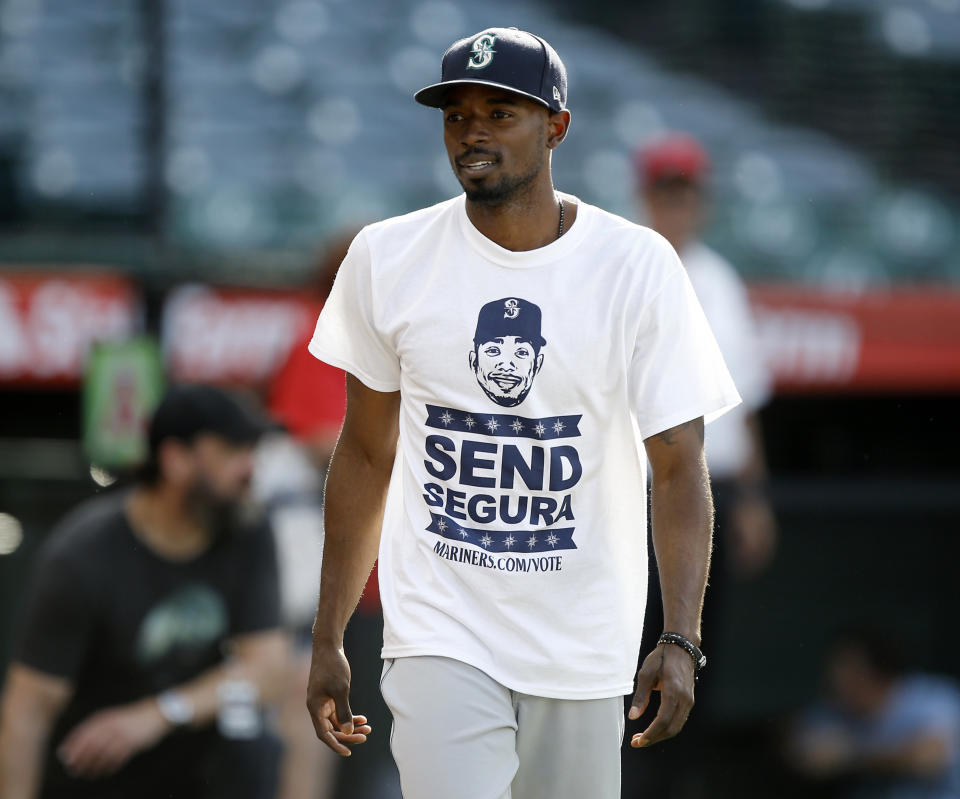 The Mariners’ Dee Gordon wears a “Send Segura” T-shirt during warmups Tuesday as part of a team campaign to have fans vote for Jean Segura for the All-Star Game. (AP)