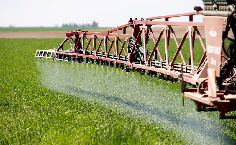 FILE PHOTO: A tractor of the Poschinger Bray'sche Gueterverwaltung company applies liquid nitrogen fertilizer to a wheat field in Irlbach