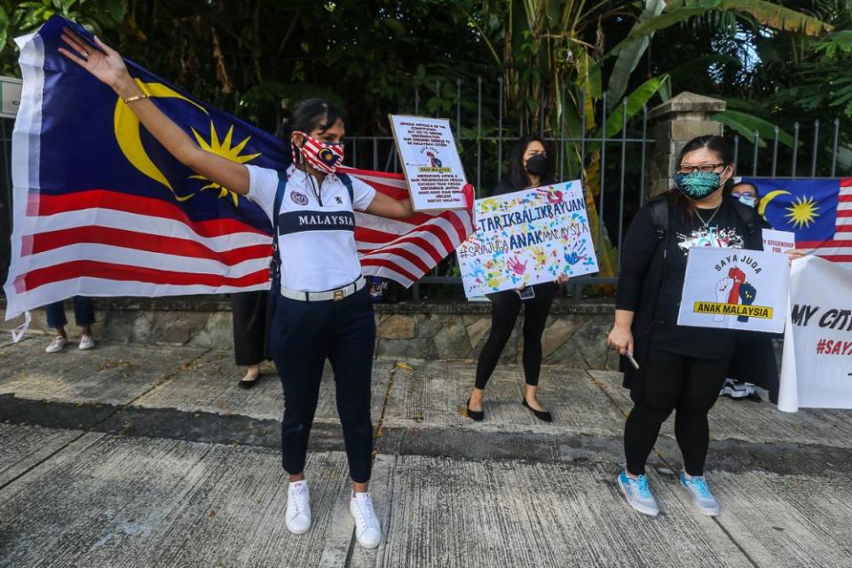 Malaysian mothers and members of Family Frontiers hold up placards demanding equal citizenship rights for Malaysians outside the Parliament building in Kuala Lumpur September 23, 2021. — Picture by Yusof Mat Isa